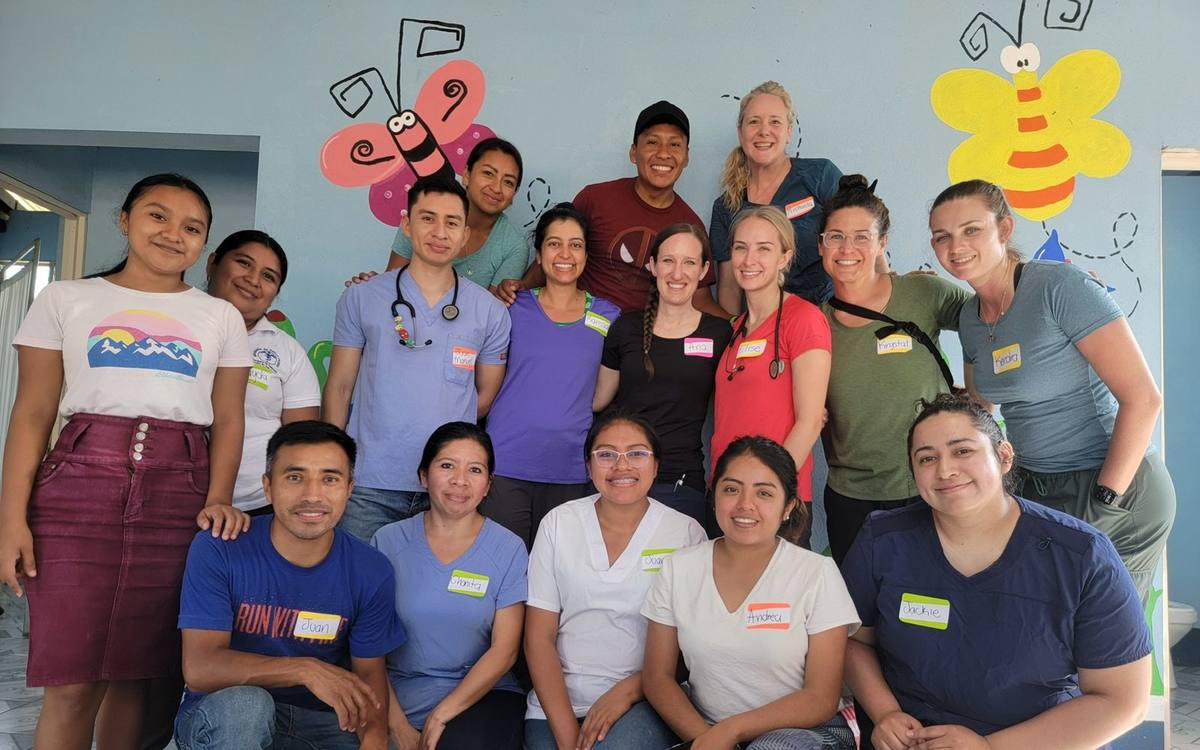 Local and visiting healthcare team group portrait in a clinic, Chicacao, Guatemala.
